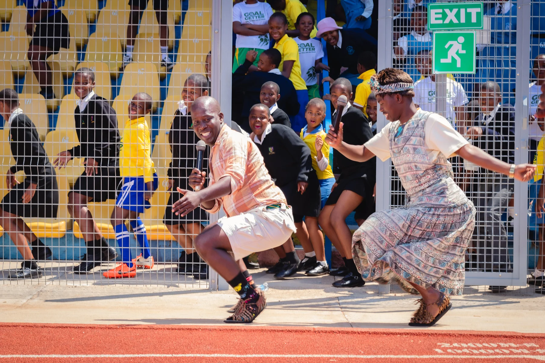 Participants playing football together on the stadium pitch