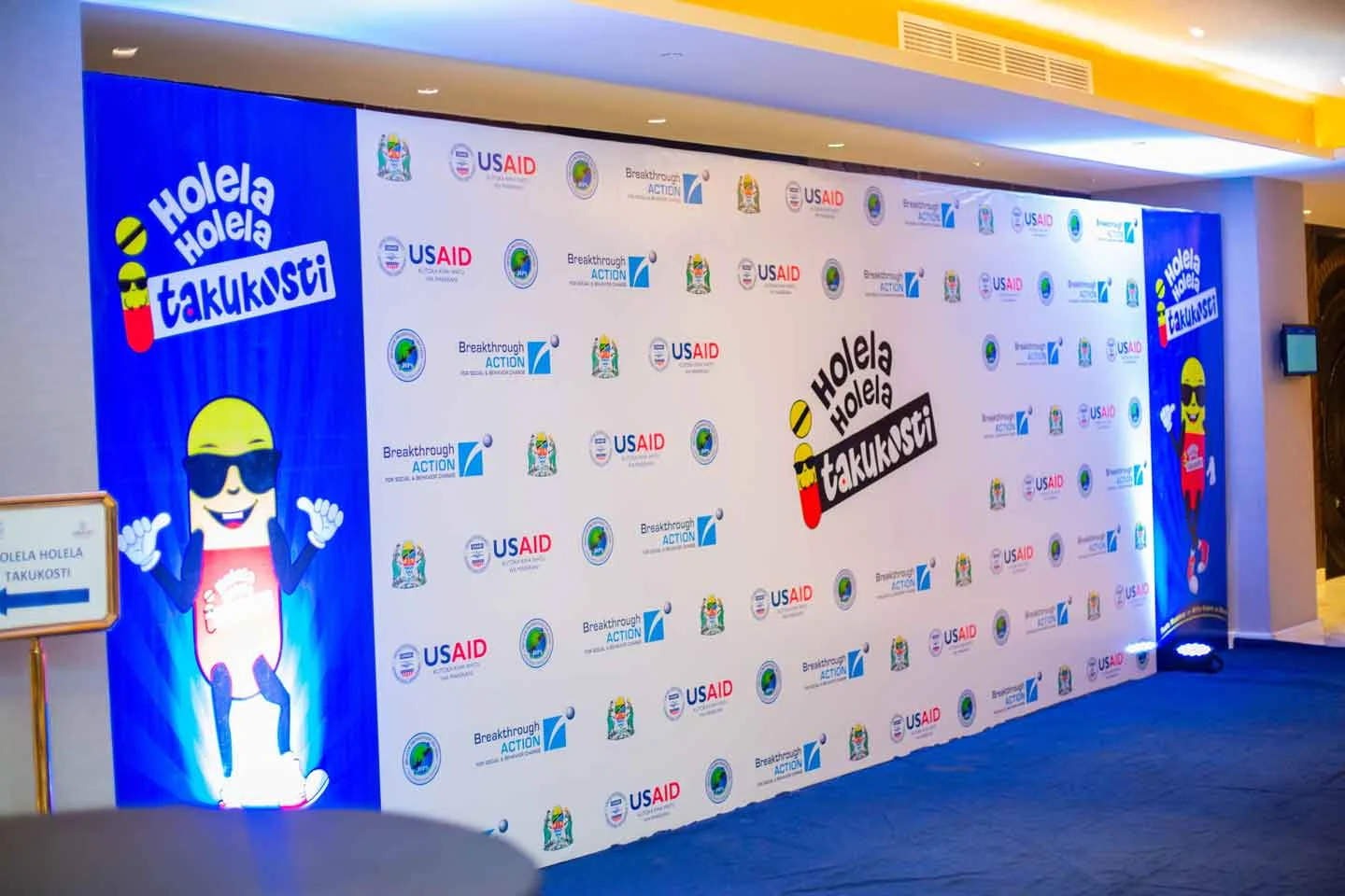 Campaign identity across the launch photo wall